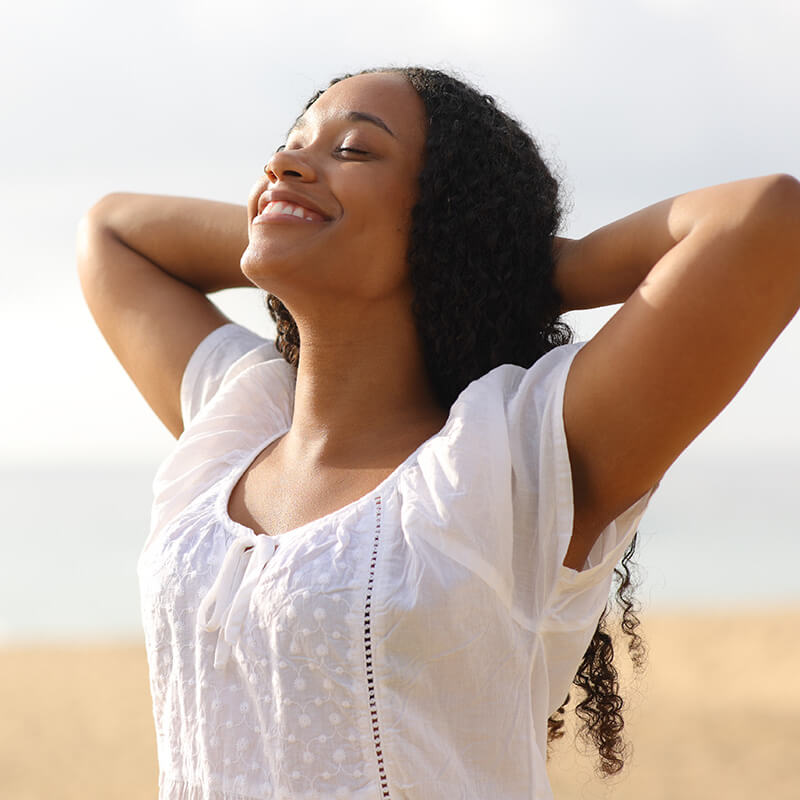 Woman at the beach in the sun