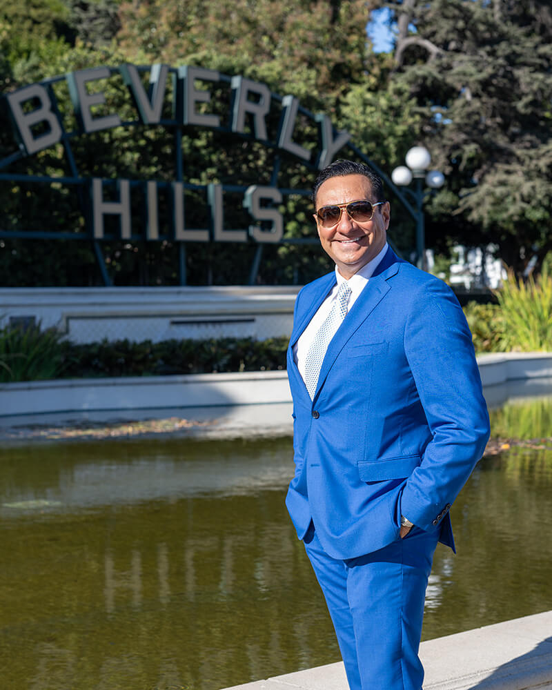 Dr. Kadz standing in front of the Beverly Hills Sign