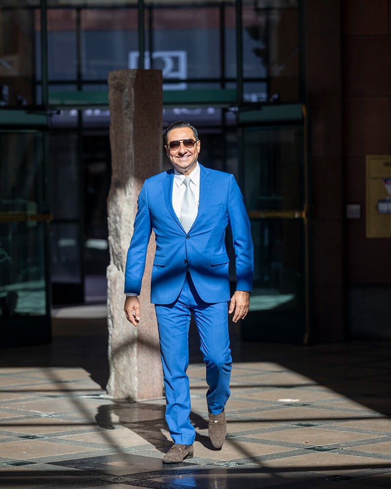 Dr. Kadz in a blue suit walking