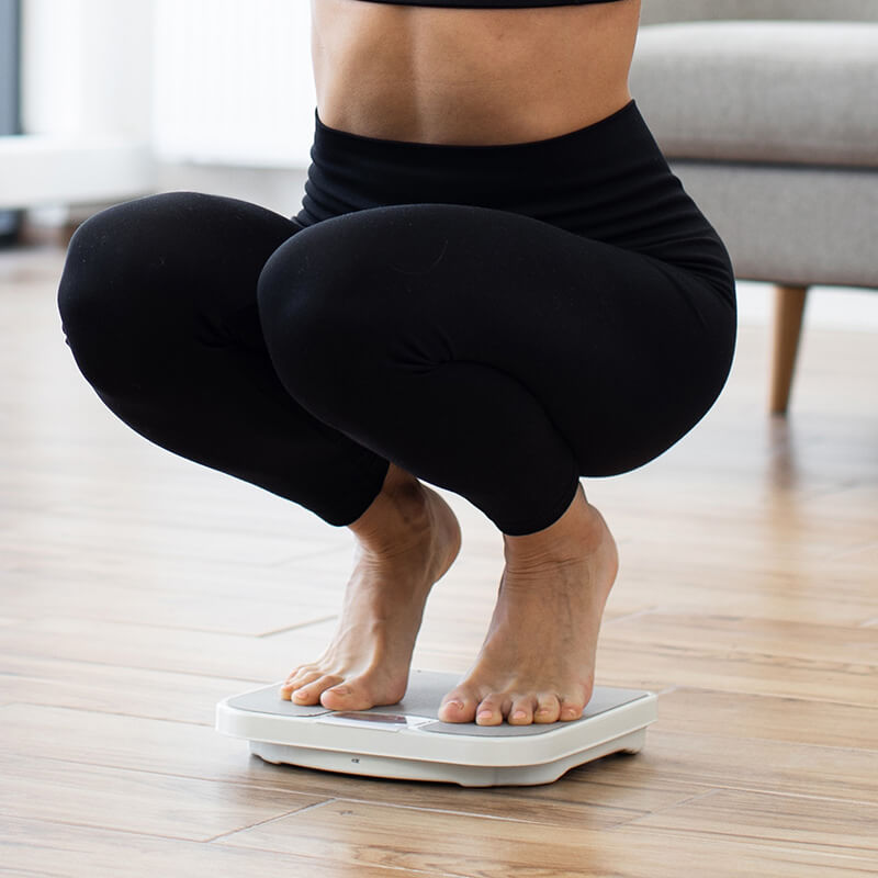 Woman weighing herself on a scale